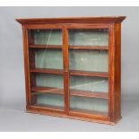 An Edwardian walnut display cabinet with moulded cornice, fitted adjustable shelves enclosed by