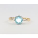 An 18ct yellow gold blue topaz and diamond dress ring size P, 3.1 grams