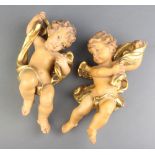 A pair of carved limewood figures of cherubs 22cm x 10cm