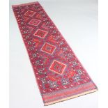 A blue and red ground Mashwani runner with 5 diamonds to the centre and multi row border, 256cm x