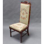 A Victorian rosewood framed nursing chair, the back and seat upholstered in Berlin woolwork