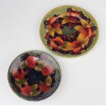 Two Walter Moorcroft shallow dishes decorated with pomegranate design 17cm and 14cm diamThe 2nd item