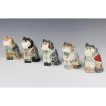Five Rye Cinque Port Pottery cats, dressed and decorated with flowers, all with glass eyes 12cm