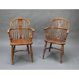 An 18th/19th Century elm Windsor stick and rail back carver chair with crinoline stretcher raised on