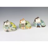 Three Rye Cinque Port Pottery cats, 1 decorated yellow flowers, 1 a green coat and the third