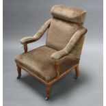 A Victorian oak show frame open arm chair upholstered in green material raised on turned supports