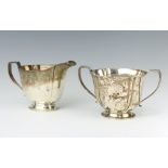 A silver cream jug and 2 handled sugar bowl on spreading foot, Birmingham 1935, 396 grams