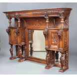 A Victorian heavily carved oak rectangular 3 section over mantel mirror with moulded and arched