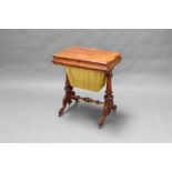 A Victorian rectangular figured walnut work table with deep basket, raised on carved turned supports