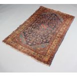 An Afghan blue and tan ground rug with diamond shaped medallion to the centre within a multi row