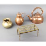 An Art Nouveau planished copper kettle with bakelite handle, a pierced brass footman, a Jersey