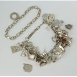 A silver charm bracelet and minor silver jewellery 100 grams