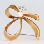 A 14ct yellow gold seed pearl and diamond ribbon brooch, 6.2 grams, 38mm