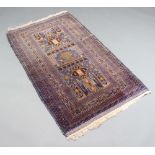 A blue and brown ground Belouche rug, the central medallion within a multi row border 144cm x 89cm