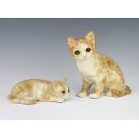 A Jenny Winstanley reclining cat with glass eyes 17cm, ditto seated cat 20cm There is crackling to
