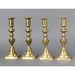 Two pairs of 19th Century brass candlesticks with knopped stems and ejectors 23cm