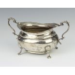 A silver sugar bowl with scroll handle, shell knees and scroll feet, Sheffield 1916 185 grams