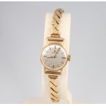 A lady's 9ct yellow gold Omega wristwatch on a gilt expanding bracelet with box