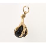 A 9ct yellow gold onyx claw pendant 1.9 grams