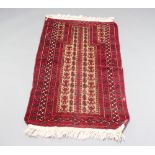 A red, brown and black ground Belouche prayer rug 132cm x 76cm Some moth damage and signs of wear