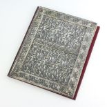 A silver plated repousse mounted blotter binder with formal floral scrolls