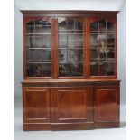 An Edwardian Chippendale style mahogany bookcase, the upper section with moulded and dentil