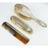 A silver dressing table set comprising comb, clothes brush and hair brush Chester 1921