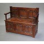 An oak hall settle with hinged lid and linen fold decoration 90cm h x 112cm w x 40cm d