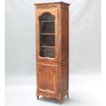 A French carved oak bookcase, the upper section with moulded cornice fitted adjustable shelves,