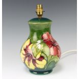 A Moorcroft baluster table lamp, the green ground decorated Hibiscus design 23cm