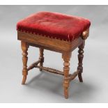 A Victorian rectangular rosewood adjustable piano stool with overstuffed seat, raised on turned