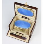 A cased silver and guilloche enamel childs brush set comprising hair brush, comb and mirror,