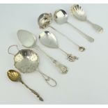 A George III silver caddy spoon with shell bowl, rubbed marks and minor spoons, 150 grams