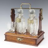 An Edwardian plated mounted 2 bottle tantalus with fitted drawer and 3 later glasses The decanters