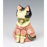 A Rye Pottery cat designed by Joan and David De Bethel wearing a dress with glass eyes, inscribed on