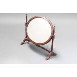 A Georgian style oval plate dressing table mirror contained in a mahogany swing frame on turned