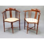 A pair of Edwardian inlaid mahogany tub back chairs, seats upholstered in Berlin tapestry, raised on