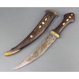 An Eastern dagger with 23cm engraved blade contained in an hardwood and mother of pearl scabbard