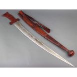 An Eastern sword with 71cm curved and etched blade complete with leather scabbard