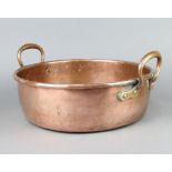 A 19th Century circular copper twin handled preserving pan 10cm h x 33cm diam. Dents to base