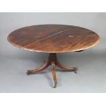 A Regency circular snap top breakfast table raised on a gun barrel column and tripod base, brass