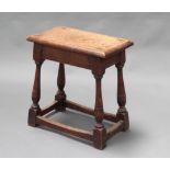 A 19th Century oak joined stool raised on turned and block supports with box framed stretcher 48cm h