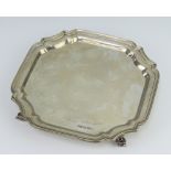 A silver card tray raised on scroll feet, Sheffield 1956, 20cm, 340 grams