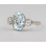 A platinum, aquamarine and diamond 3 stone ring, the centre oval aquamarine 4.5ct, flanked by 2