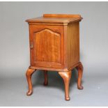 A mahogany pot cupboard with raised back and canted corners, enclosed by a panelled door, raised