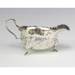 A George II repousse silver sauce boat with floral decoration and chased monogram, London 1732, 94