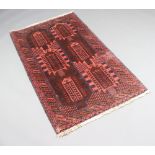 A red and brown ground Afghan rug with 6 stylised medallions to the centre within a multi row border
