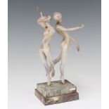 An Istvan Komaromy colour glass group of 2 naked ladies raised on a stepped marble base 26cm