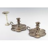 A pair of Victorian silver plated chamber sticks with scallop bases 10cm together with a spill vase
