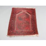 A red and blue ground Afghan rug with 2 octagons to the centre 109cm x 78cm Some moth damage